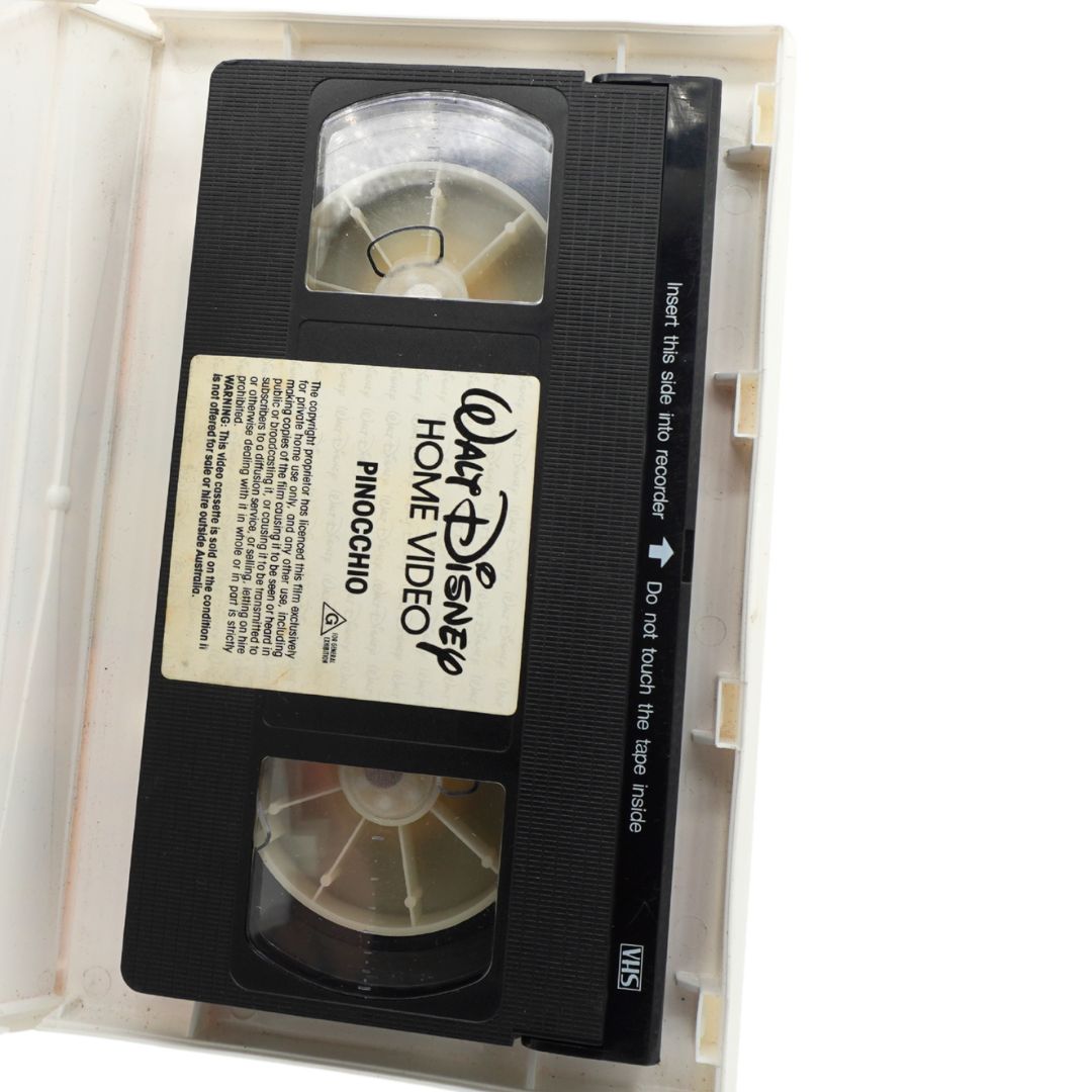 A vintage Disney Home Video 'Pinocchio' VHS tape inside a clear plastic protective case, photographed from a top-down angle.