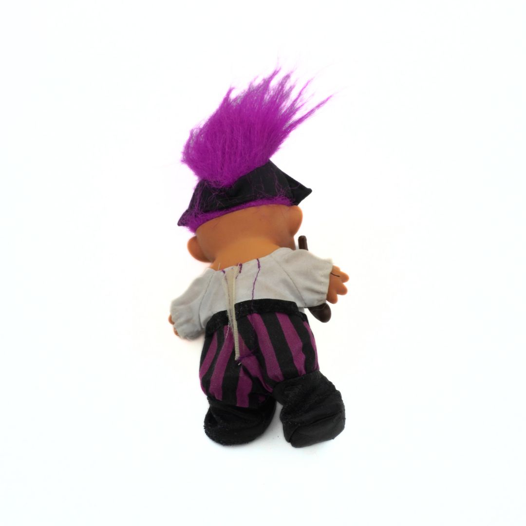 Back side of a 90s Troll doll with a purple and black pirate costume