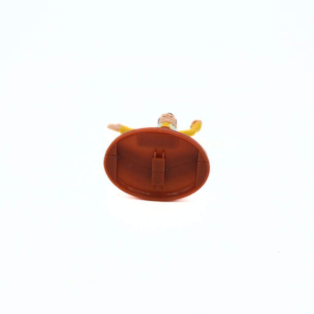 Small round brown object with a character on top on a white background