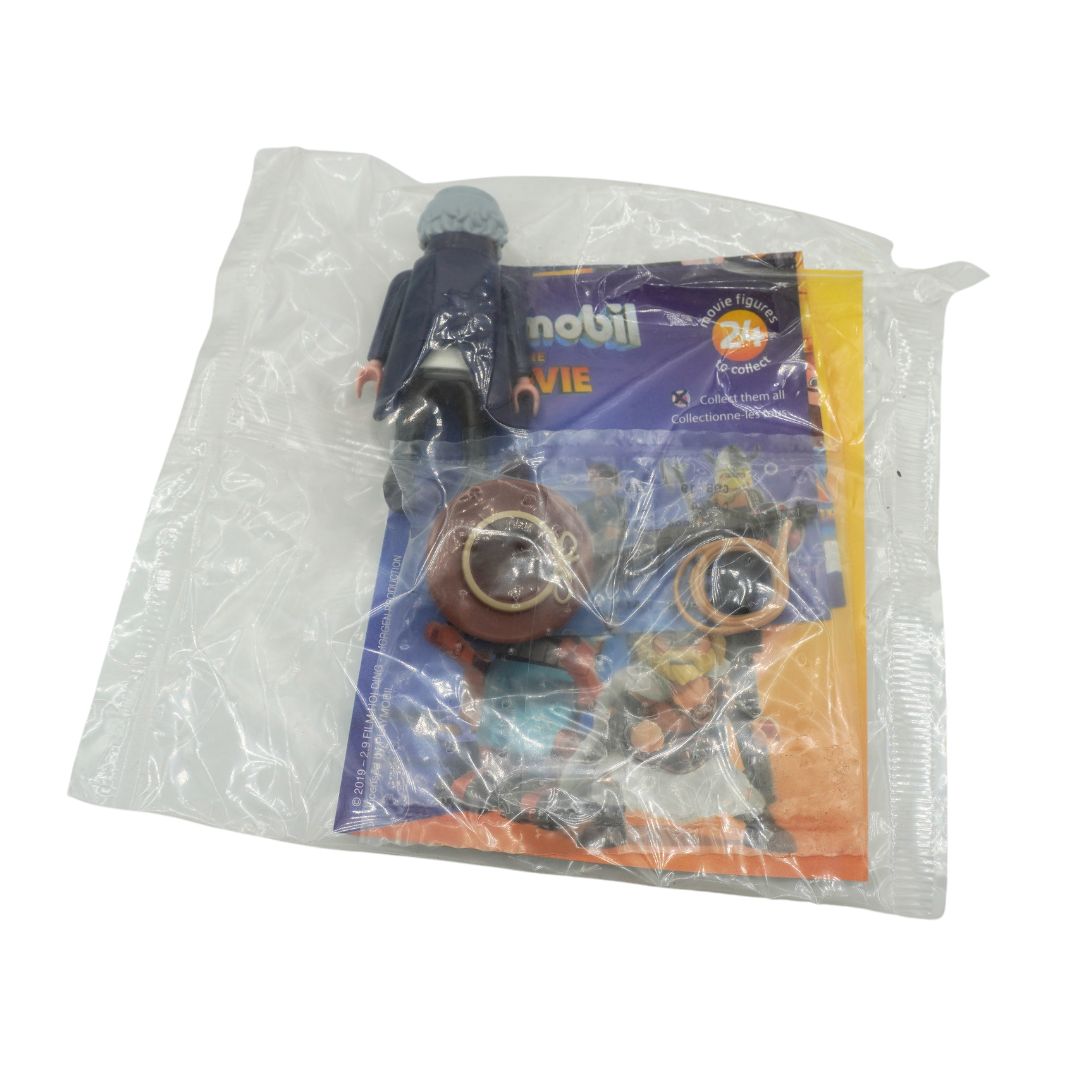 A Playmobil toy figure in its original clear plastic blister packaging, showing a dark blue figure and accessories on a branded card insert.