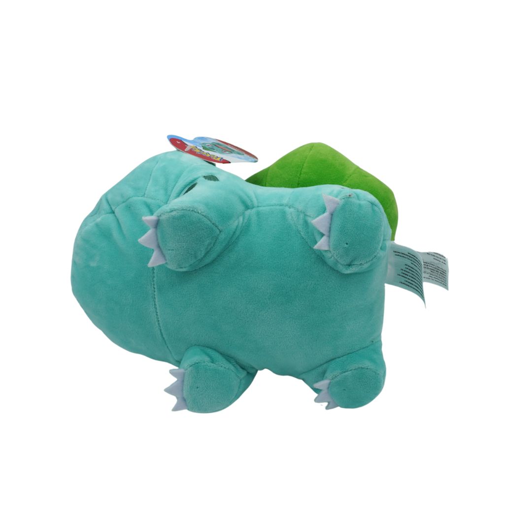 Green plush toy with a white tag on a white background