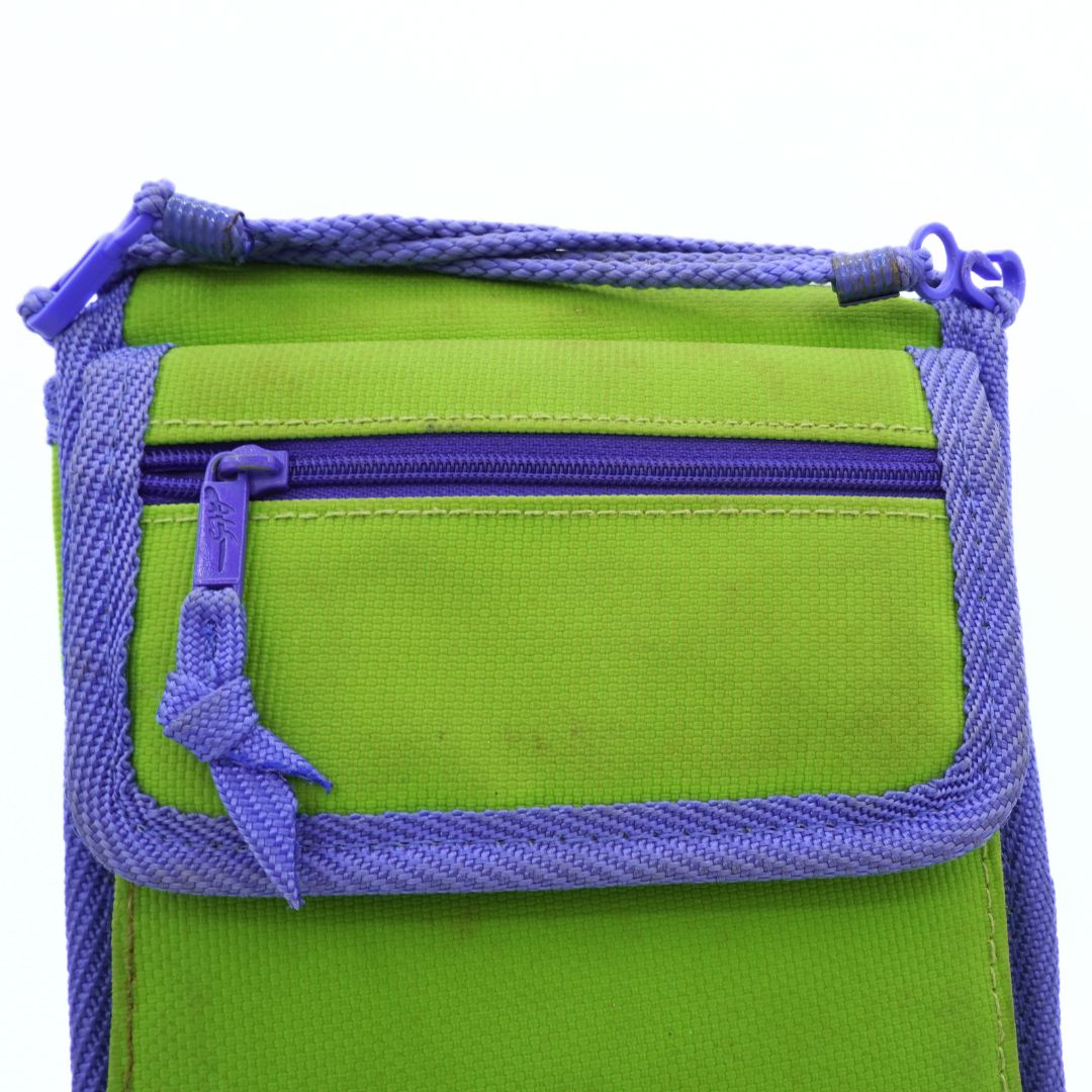 Green bag with purple zippers and drawstrings on a white background