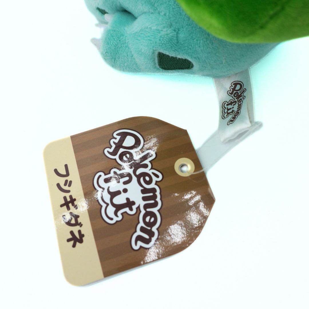 Plush toy with a 'Pokémon' tag on a white background