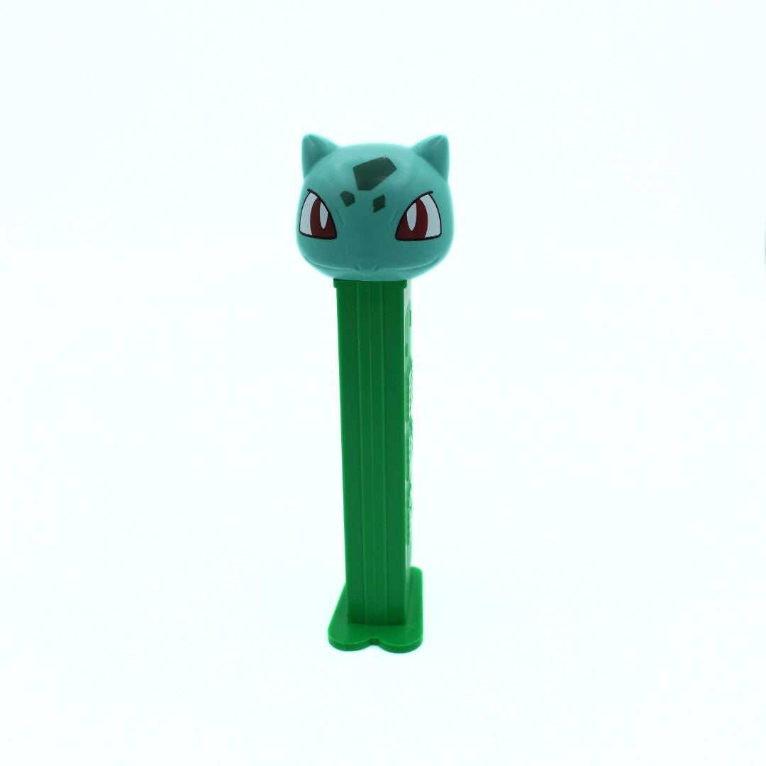 Green PEZ dispenser shaped like a cartoon character on a white background