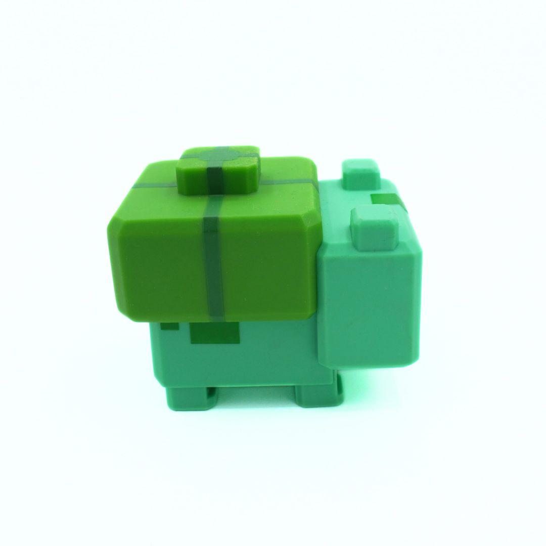 Green toy figure on a white background