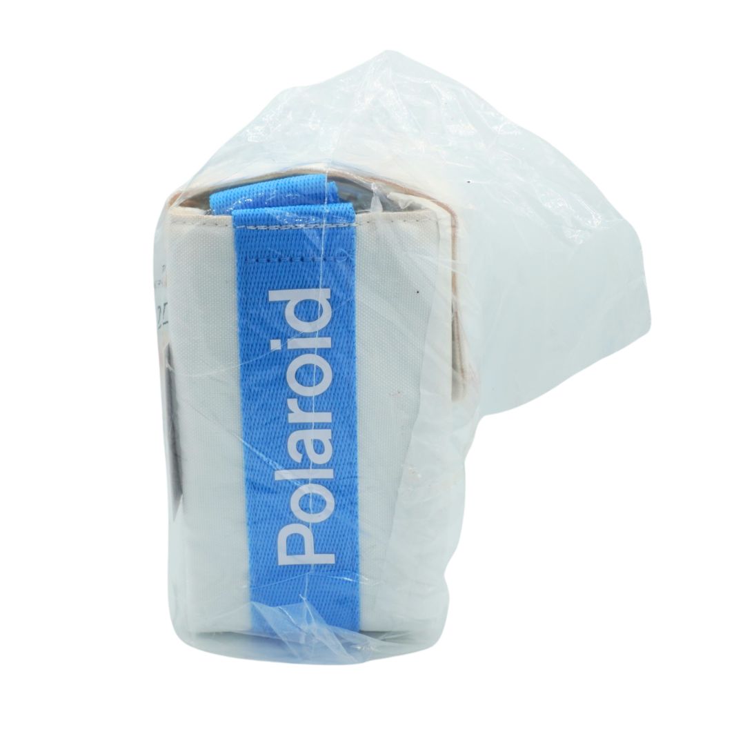 A Polaroid camera body wrapped in a clear protective plastic sleeve, featuring a prominent blue band with the white 'Polaroid' logo on the side, set against a plain white background.