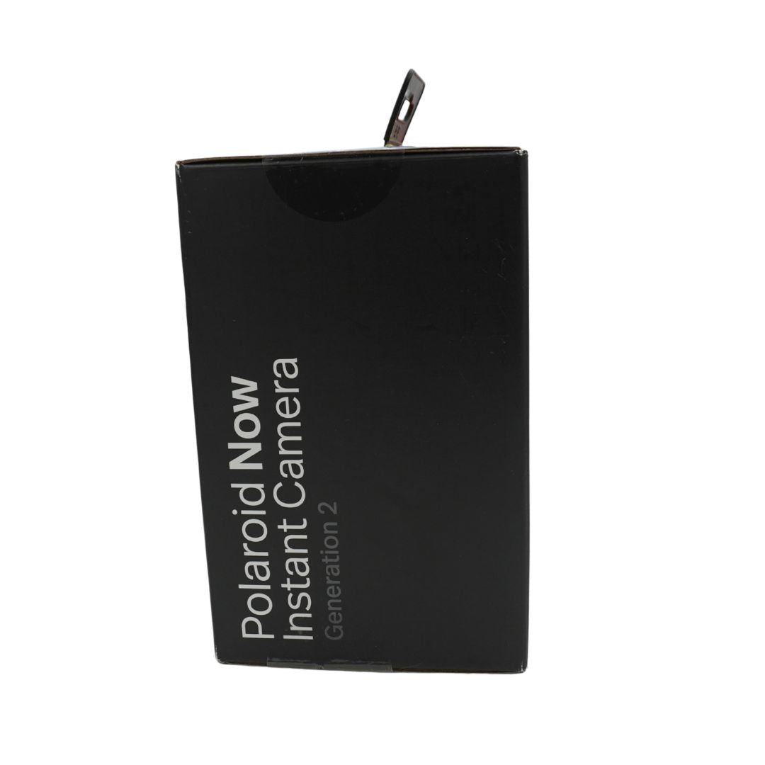 A black and white polaroid camera in a black box, titled the Polaroid Now