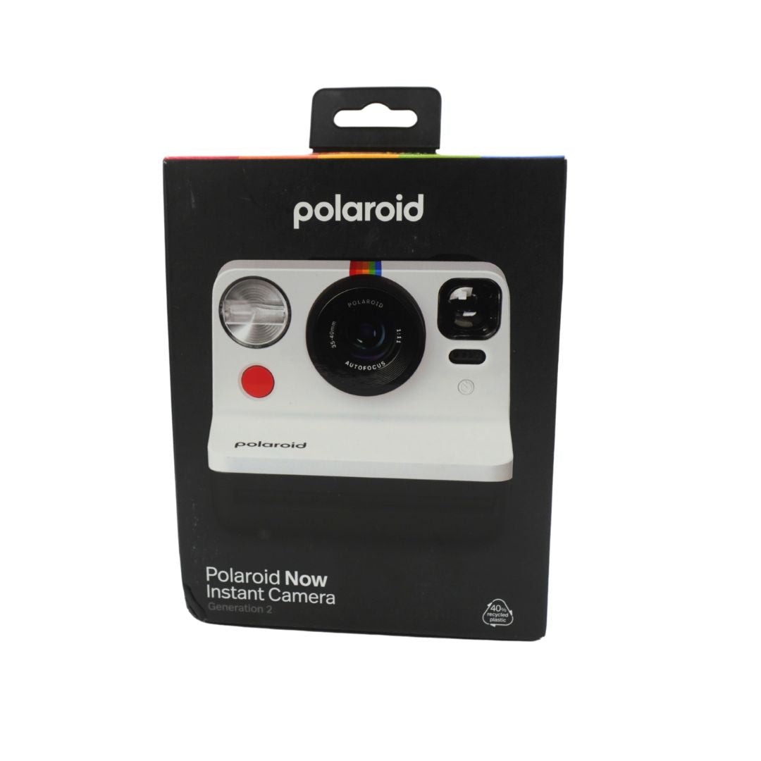 A black and white polaroid camera in a black box, titled the Polaroid Now