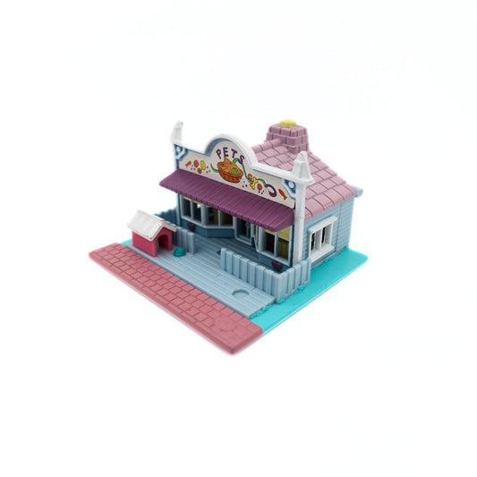 Front on image of the 1993 Bluebird Polly Pocket Pet Shop, with a pink, blue and purple colour palette.