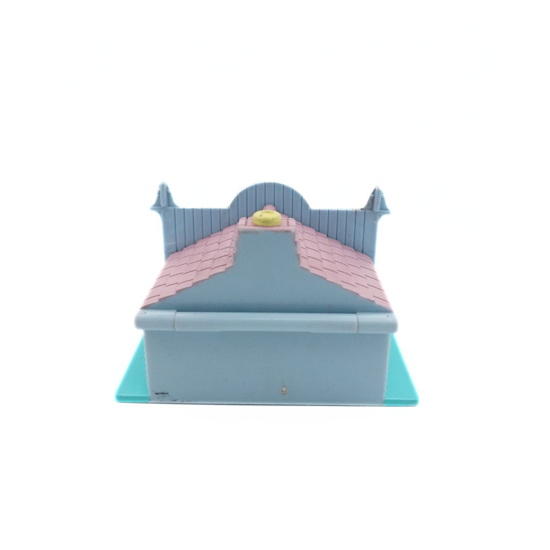 Photo of the back of the 1993 Bluebird Polly Pocket Pet Shop, with a pink, blue and purple colour palette.