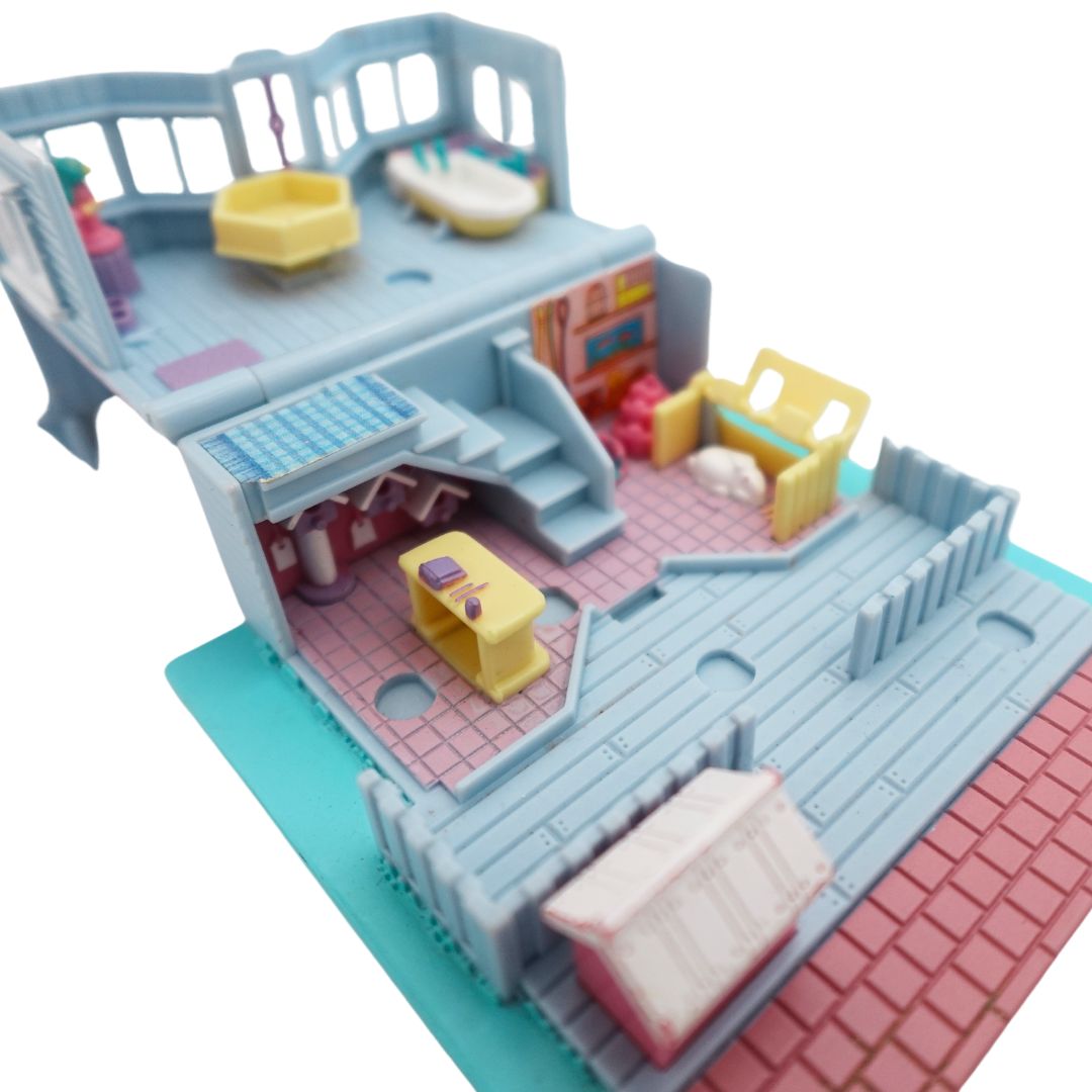 Inside image of the 1993 Bluebird Polly Pocket Pet Shop, with a pink, blue and purple colour palette.