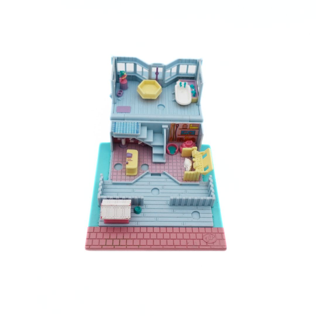 Topdown image of the 1993 Bluebird Polly Pocket Pet Shop, with a pink, blue and purple colour palette.