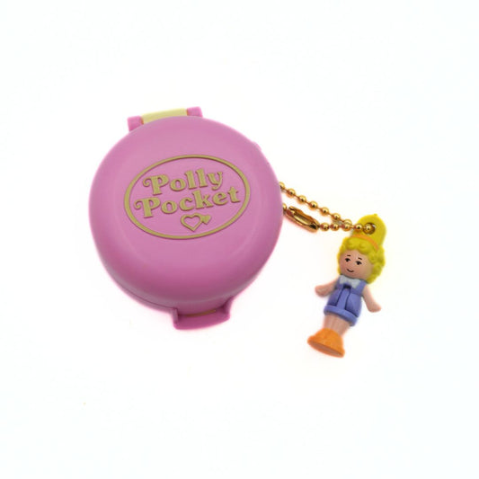 Pink Polly Pocket case with a keychain figure on a white background