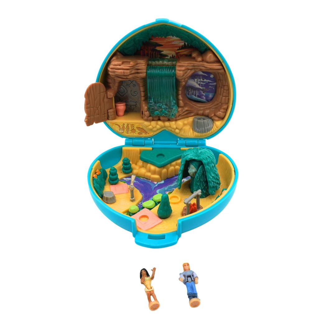 An open 90s Polly Pocket playset featuring a waterfall and small figures