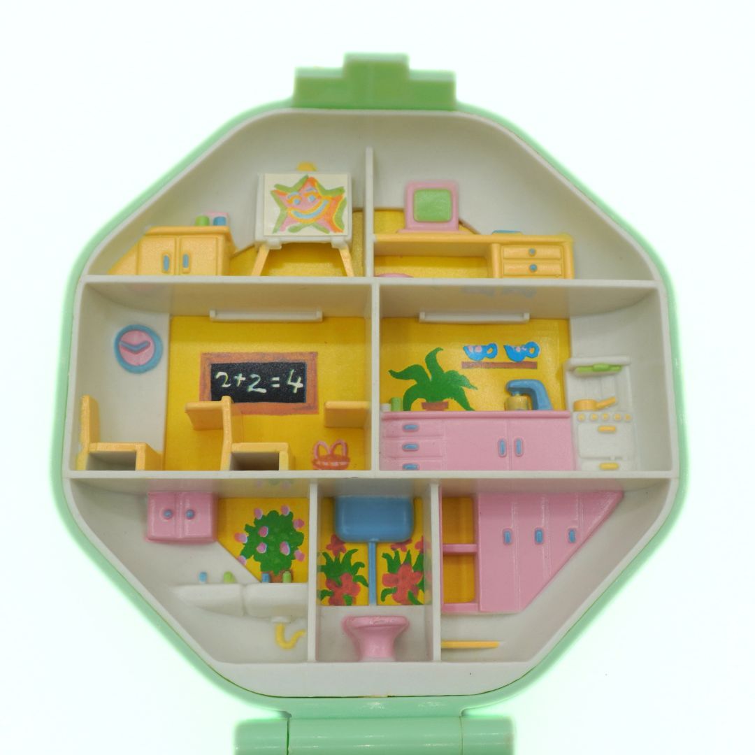 Toy classroom set with colorful furniture on a white background