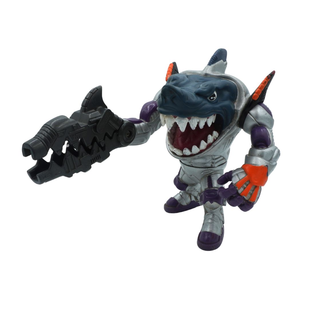 Toy figure of a shark-like character with a weapon on a white background