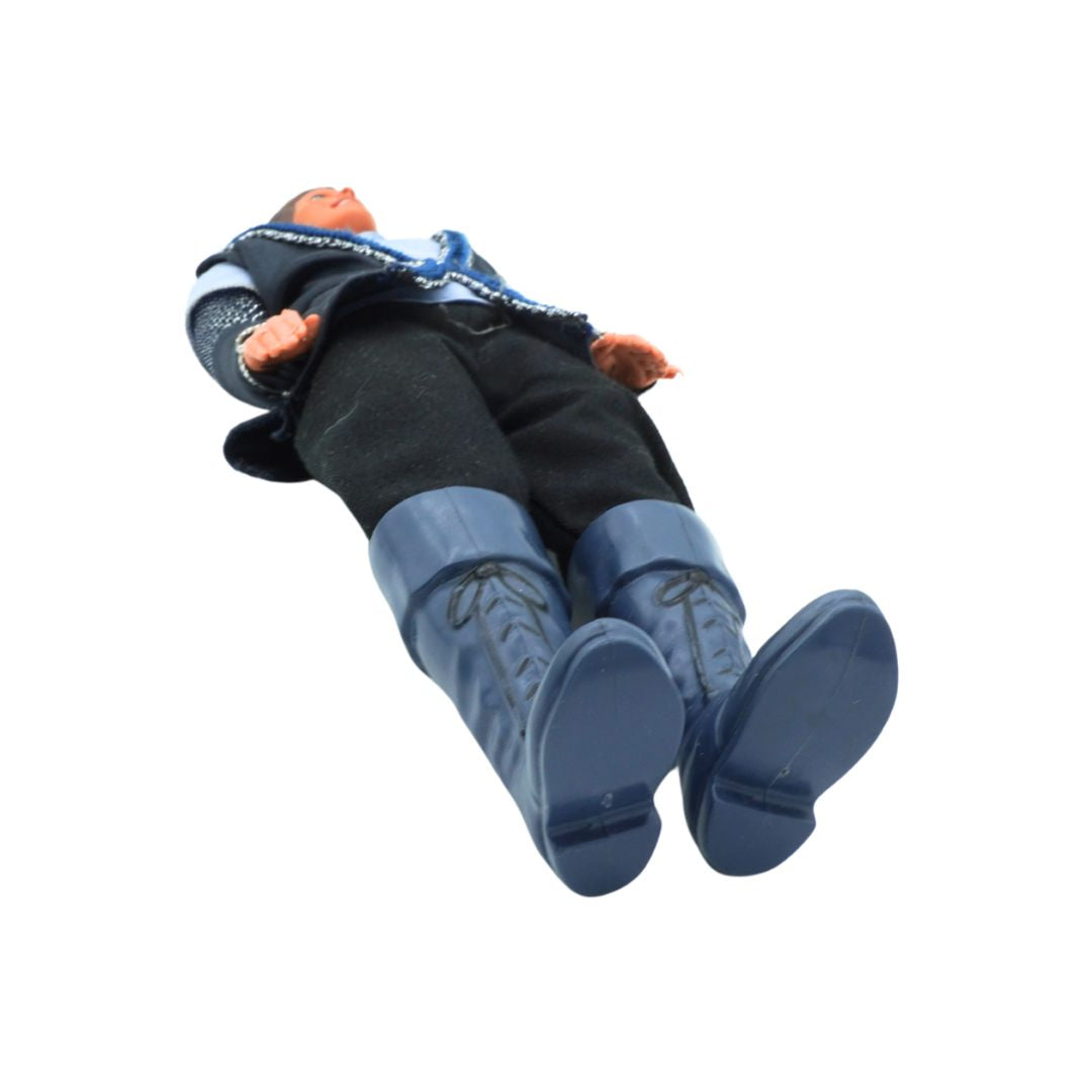 Toy figure of a person wearing blue boots on a white background