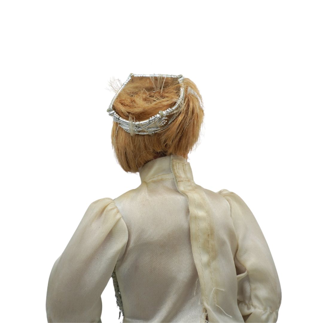 Back view of a person wearing a white outfit with a decorative headpiece on a white background