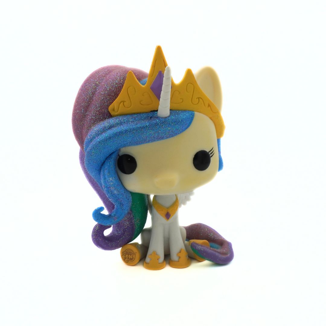 Toy figure with blue hair and a yellow crown on a white background