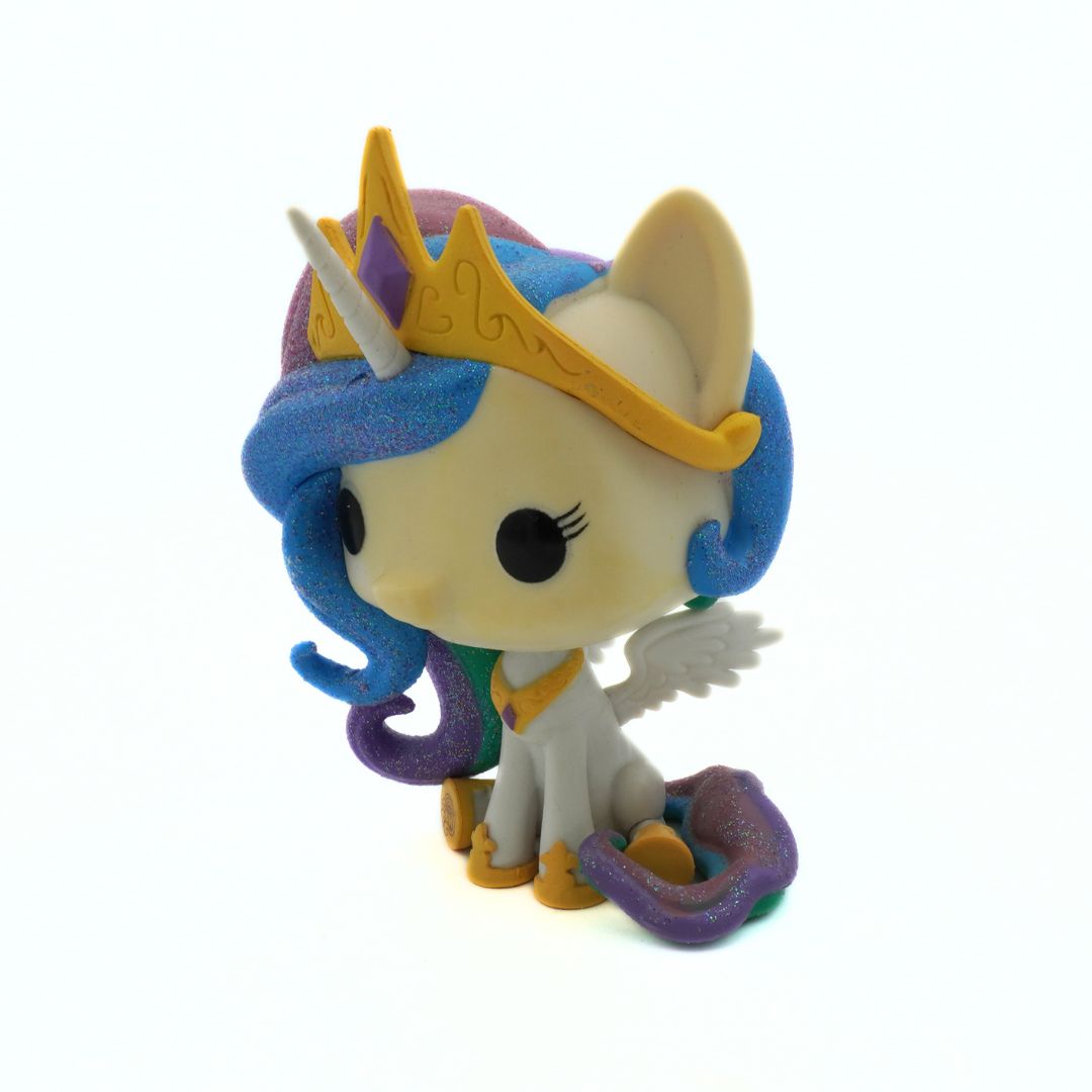 Toy figure of a unicorn with a crown on a white background