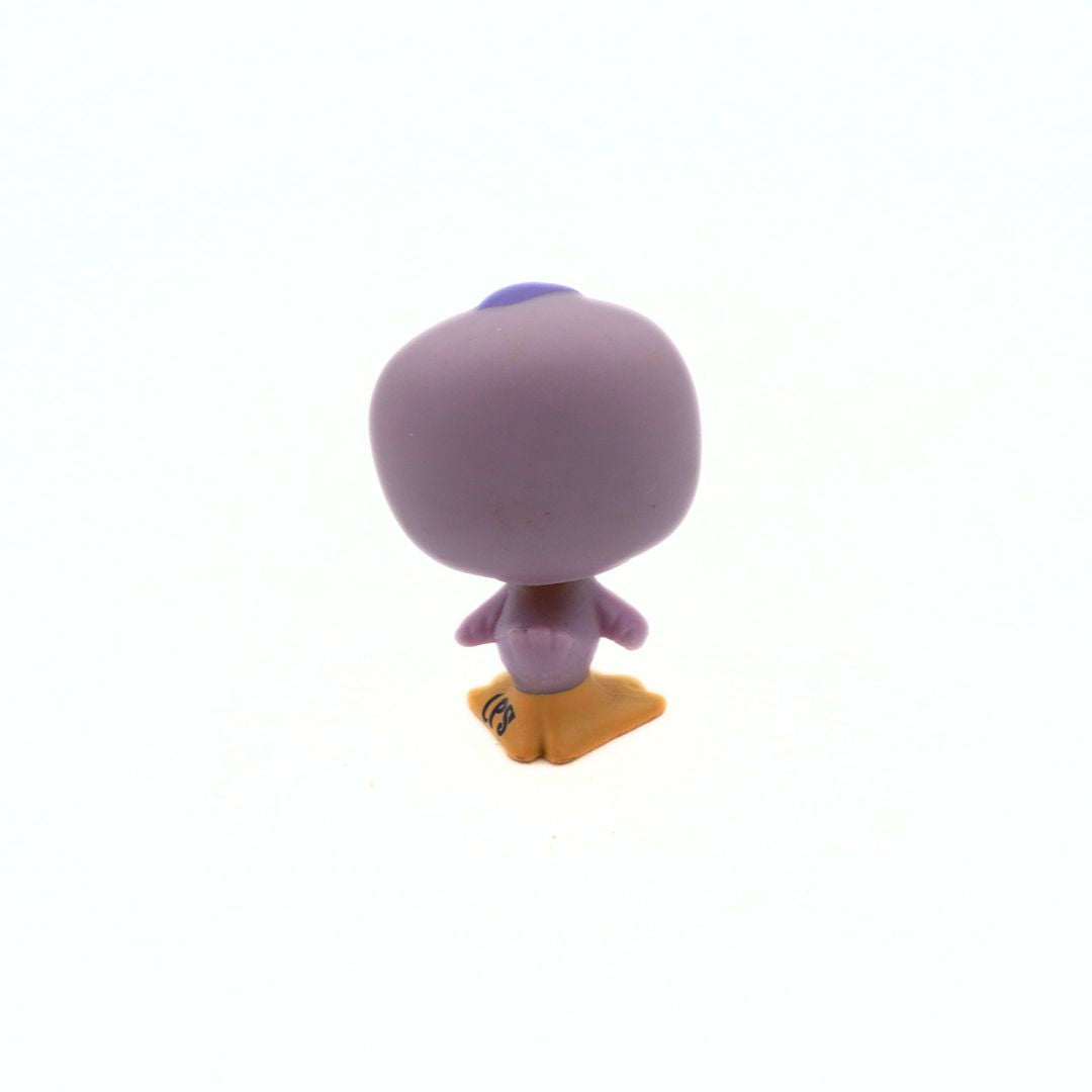Small purple figurine with a yellow base on a white background