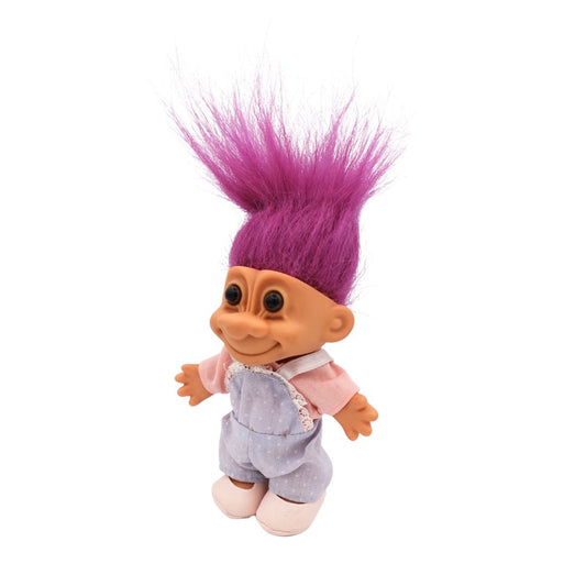 A fuchsia hair colour Troll doll released in the 80s, wearing shoes, overalls and a shirt.