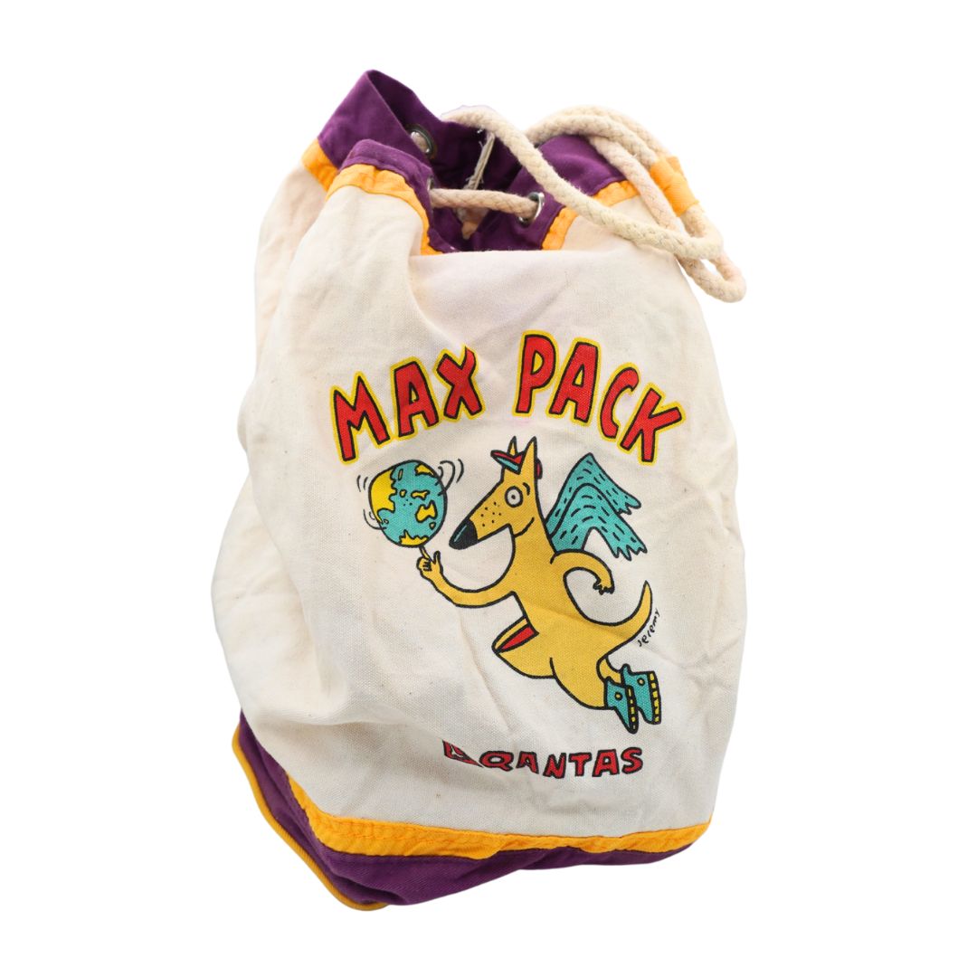 A vintage-style drawstring bag with a cream body, purple and orange trim, and a cartoon kangaroo graphic with the text 'MAX PACK' and 'QANTAS' on a white background.