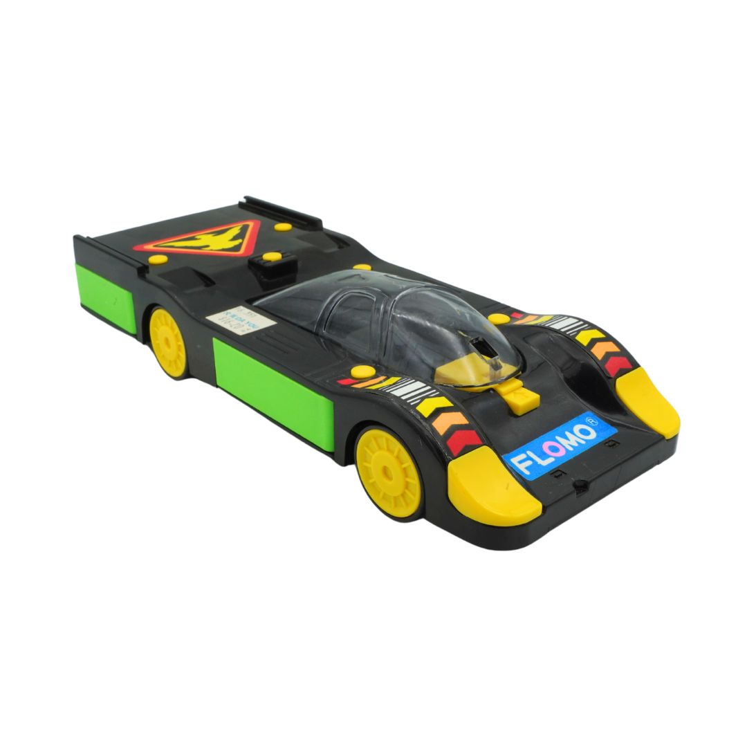 Toy race car with green, yellow, and black colors on a white background