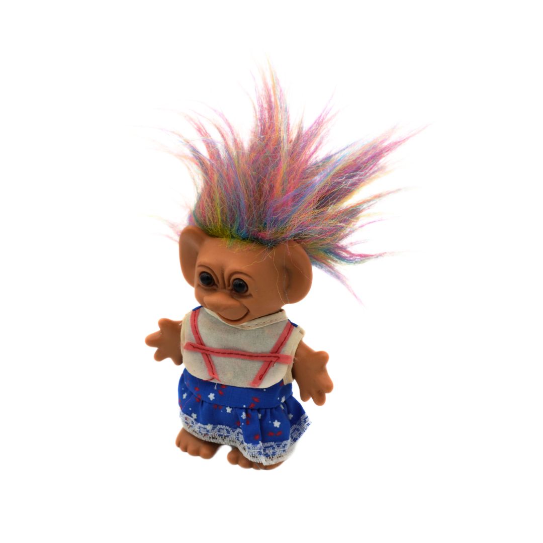 Vintage rainbow haired Troll with brown eyes and a blue dress, released by Uneeda