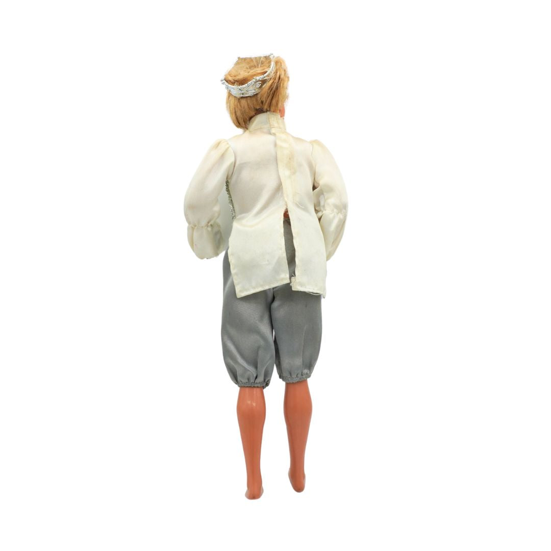 Ken doll wearing a white shirt and gray pants on a white background