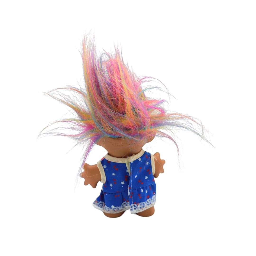 Vintage rainbow haired Troll with a blue floral dress, released by Uneeda