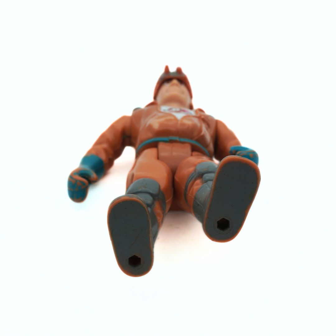 Toy figure of a character in an orange suit on a white background
