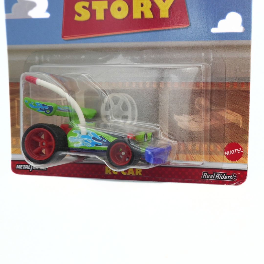 Toy car in packaging with 'Real Riders' branding on a white background