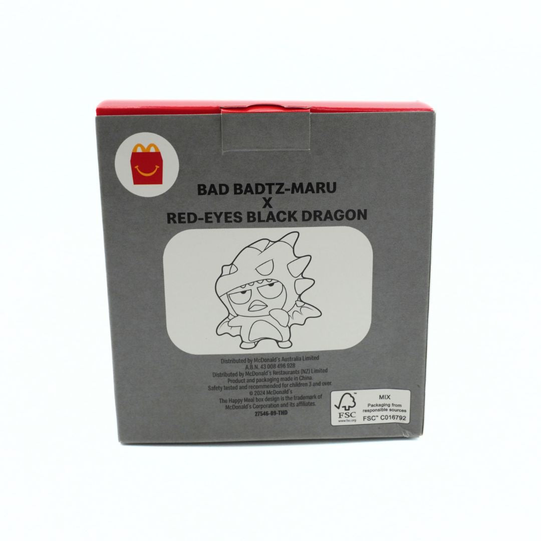 The product packaging box for the McDonald's Happy World Design x Bad Badtz-Maru Red-Eyes Black Dragon collaboration, featuring a dark gray box with a red top edge, a McDonald's logo, and character artwork.