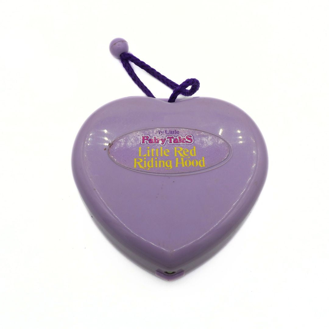 Heart-shaped purple toy with 'Little Red Riding Hood' text on a white background
