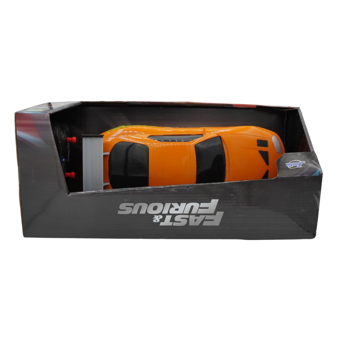 An orange and black remote control toy car inside its black retail packaging, featuring the 'Fast & Furious' logo on the box.