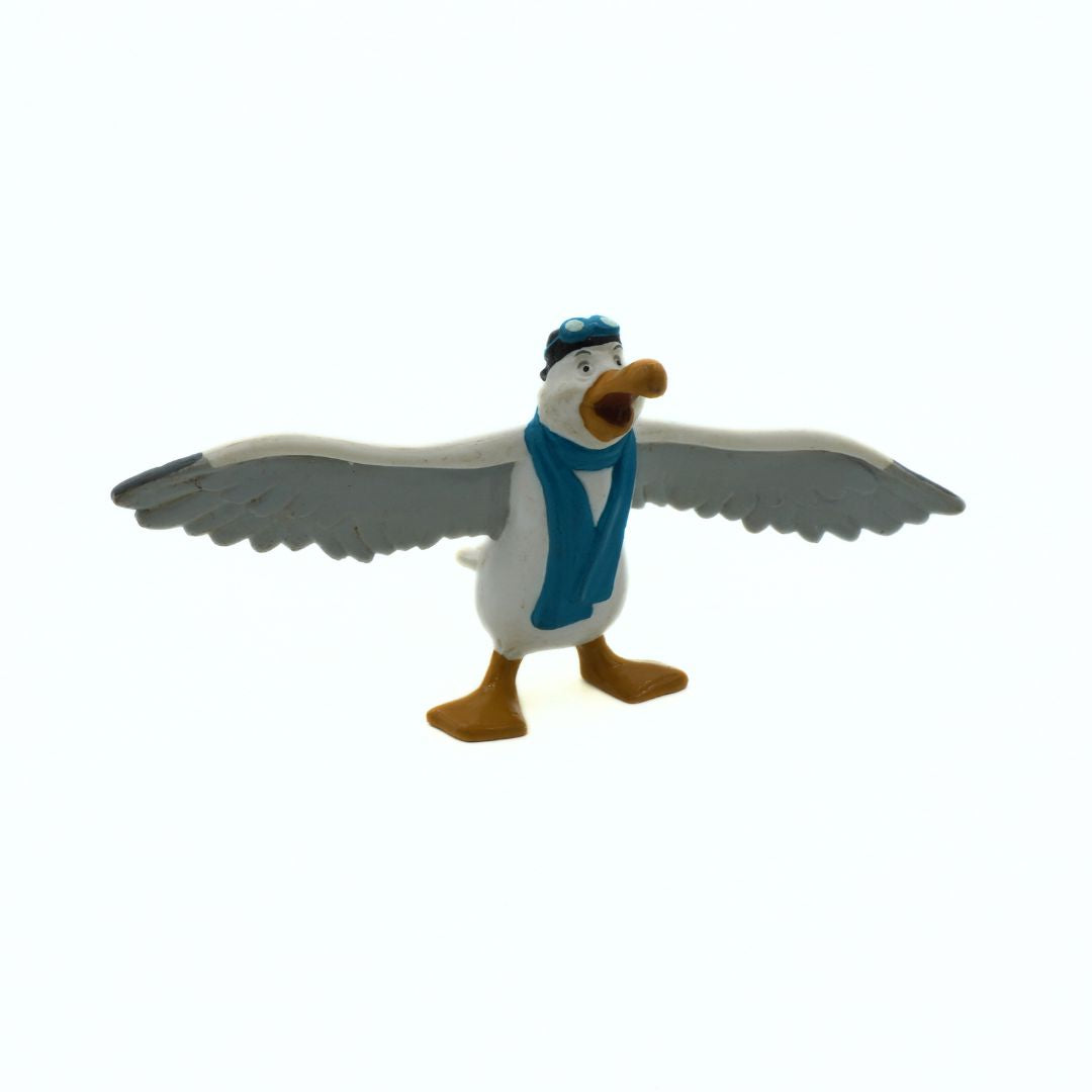 Toy figure of a bird with a blue scarf and hat on a white background