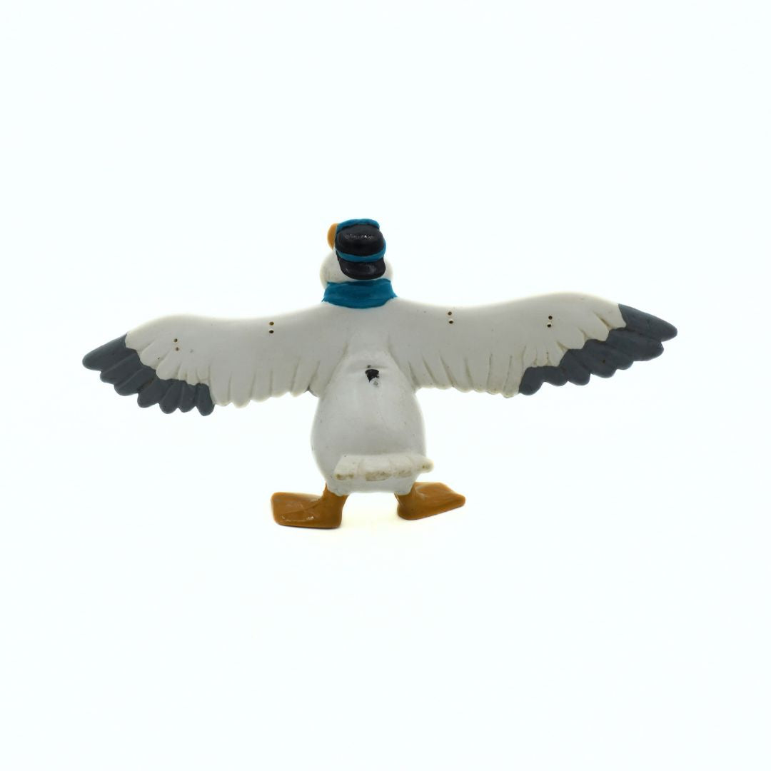Toy bird with a blue scarf on a white background