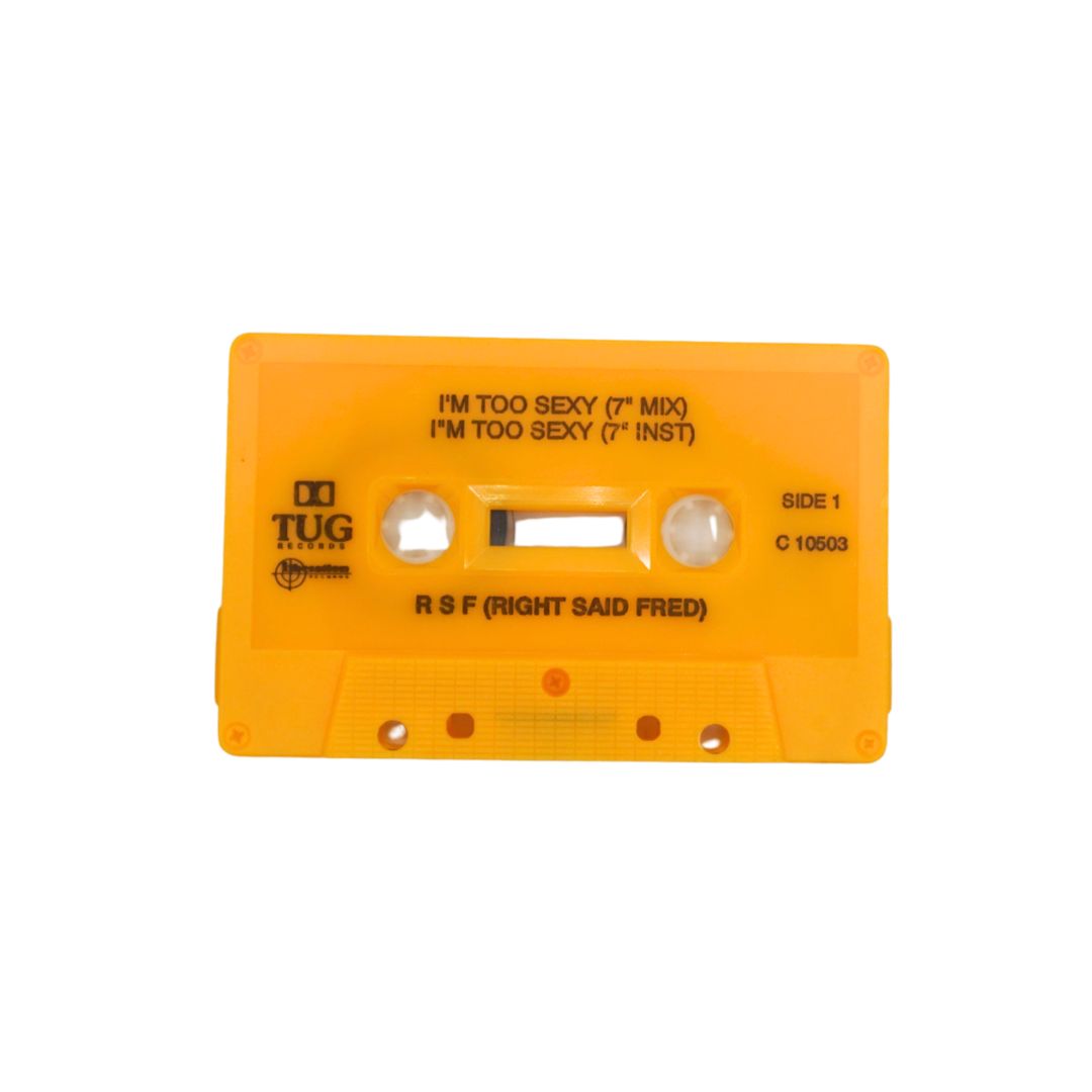 A bright yellow-orange cassette tape with printed black text, including the TUG Records logo and song title 'I'm Too Sexy (7" Mix)' by R.S.