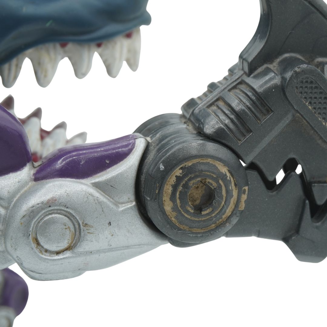 Close-up of a toy dinosaur with mechanical parts on a white background
