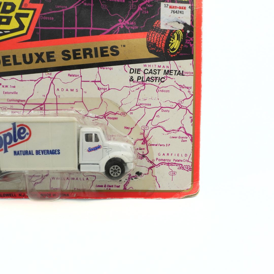 Toy truck in front of a vintage Sopapilla packaging with a map background