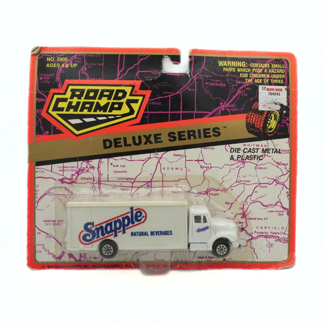 Packaged toy truck with Snapple branding on a Road Champs Deluxe Series box.