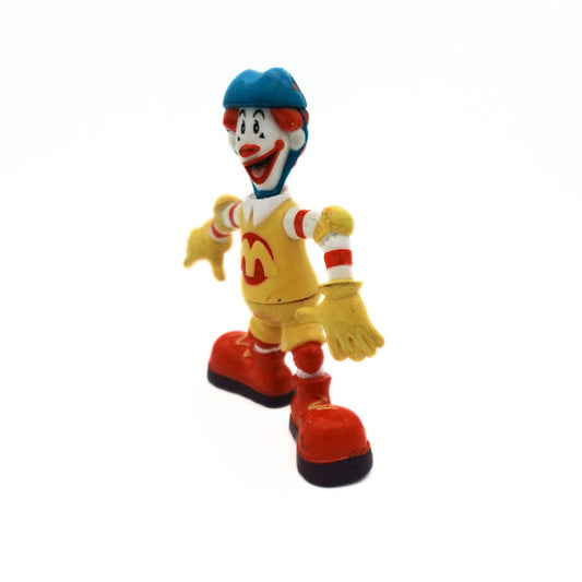 Yellow, red and white Ronald McDonald skater figurine with a blue helmet