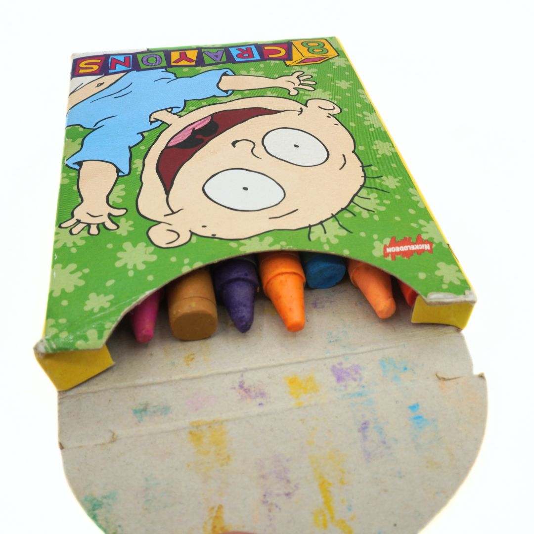 Set of colorful crayons in a cartoon character-themed box