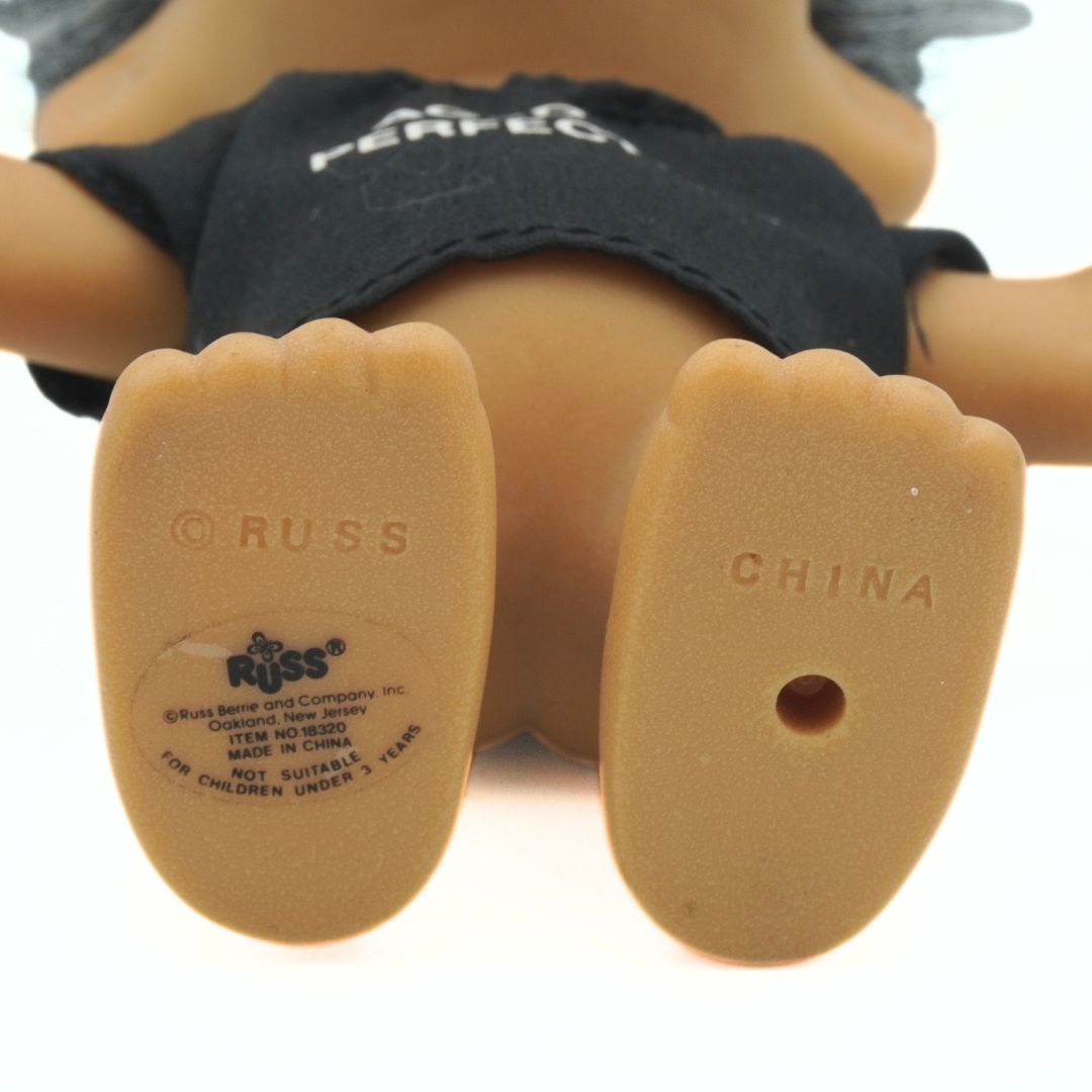 Close-up of a doll's feet with 'Russ' branding on the soles.