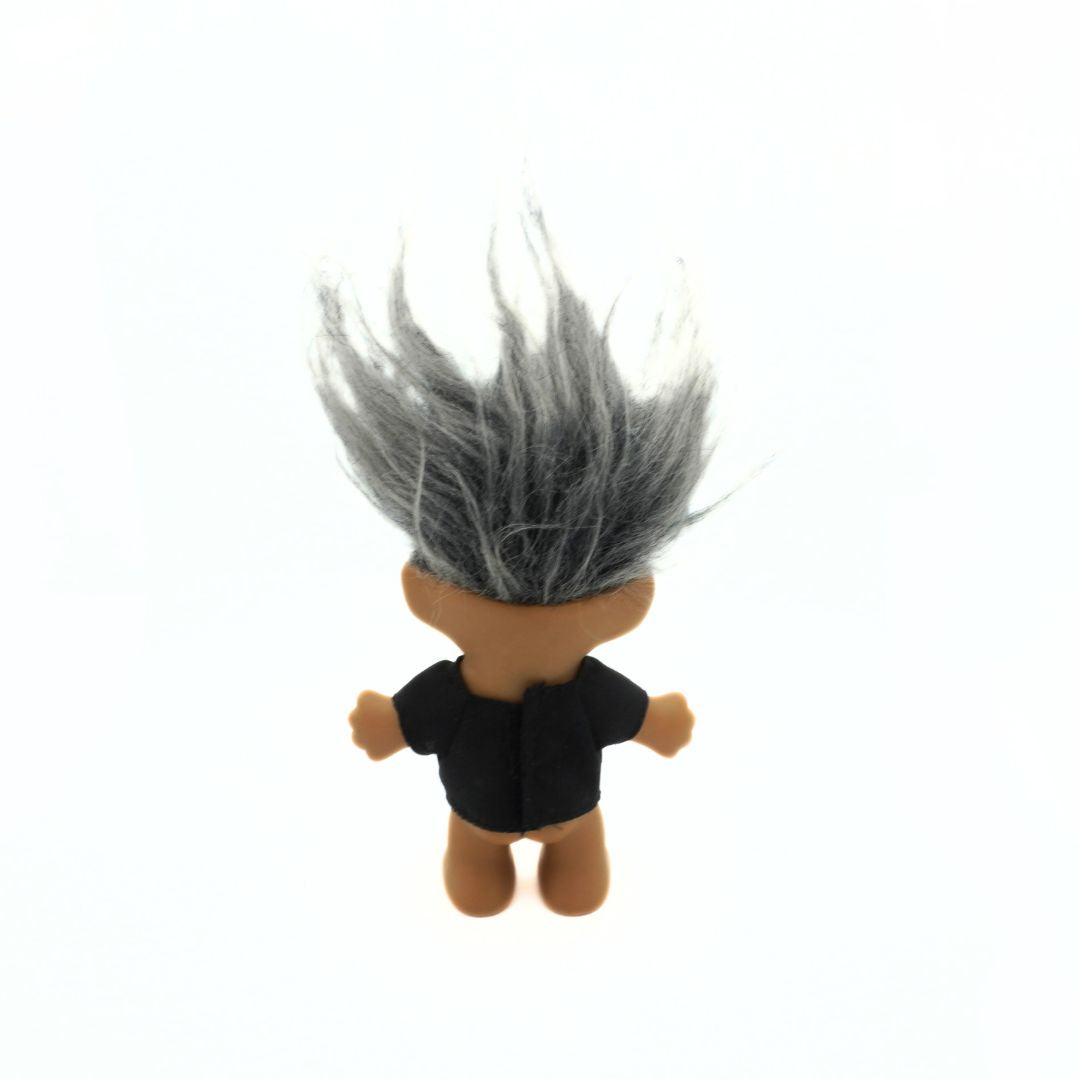 Photo of the back of a grey haired Russ troll doll wearing a black t-shirt