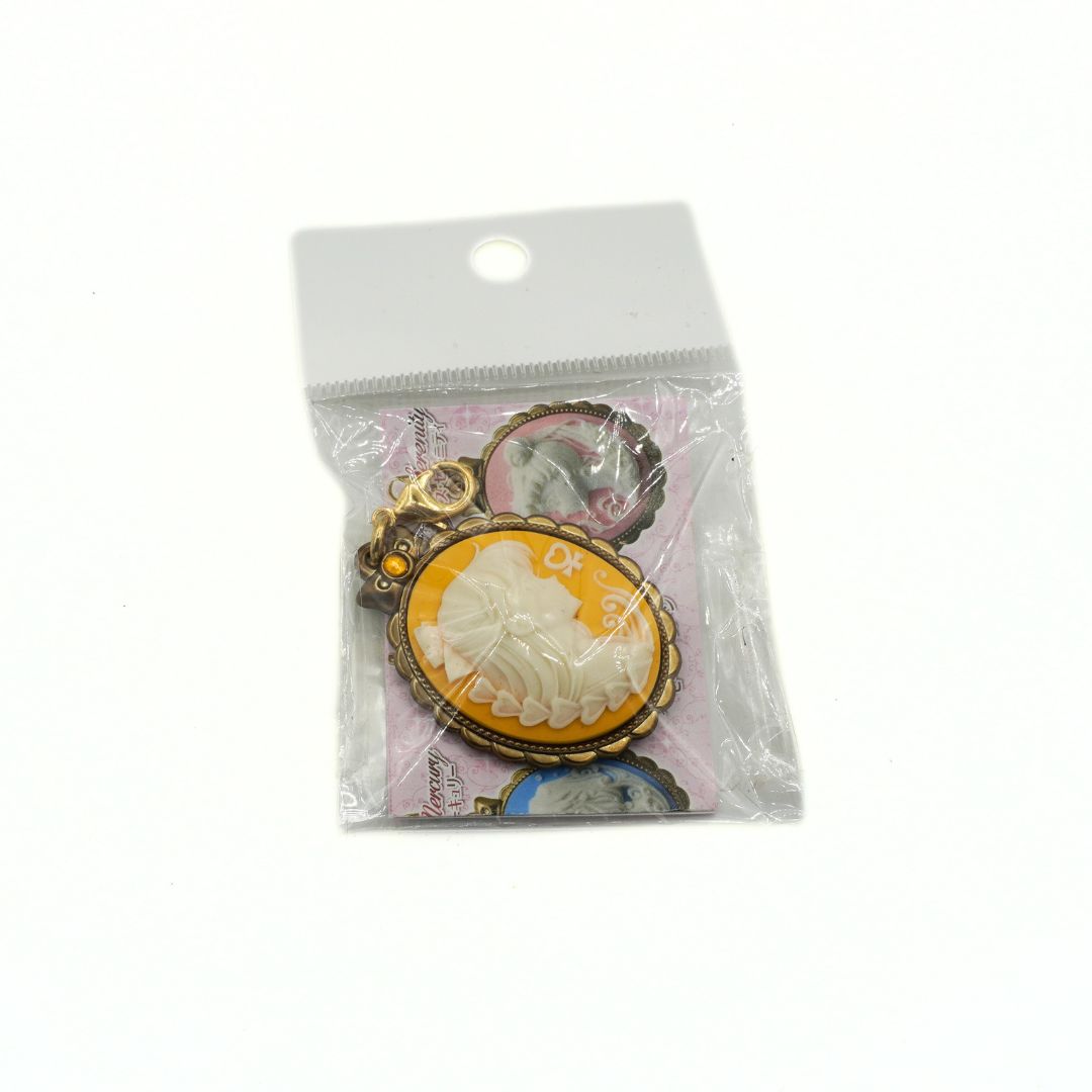Cameo style charm featuring Sailor Venus on a yellow background