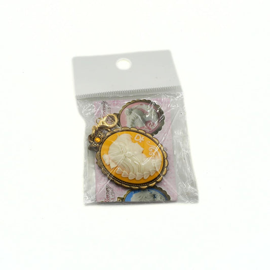 Cameo style charm featuring Sailor Venus on a yellow background