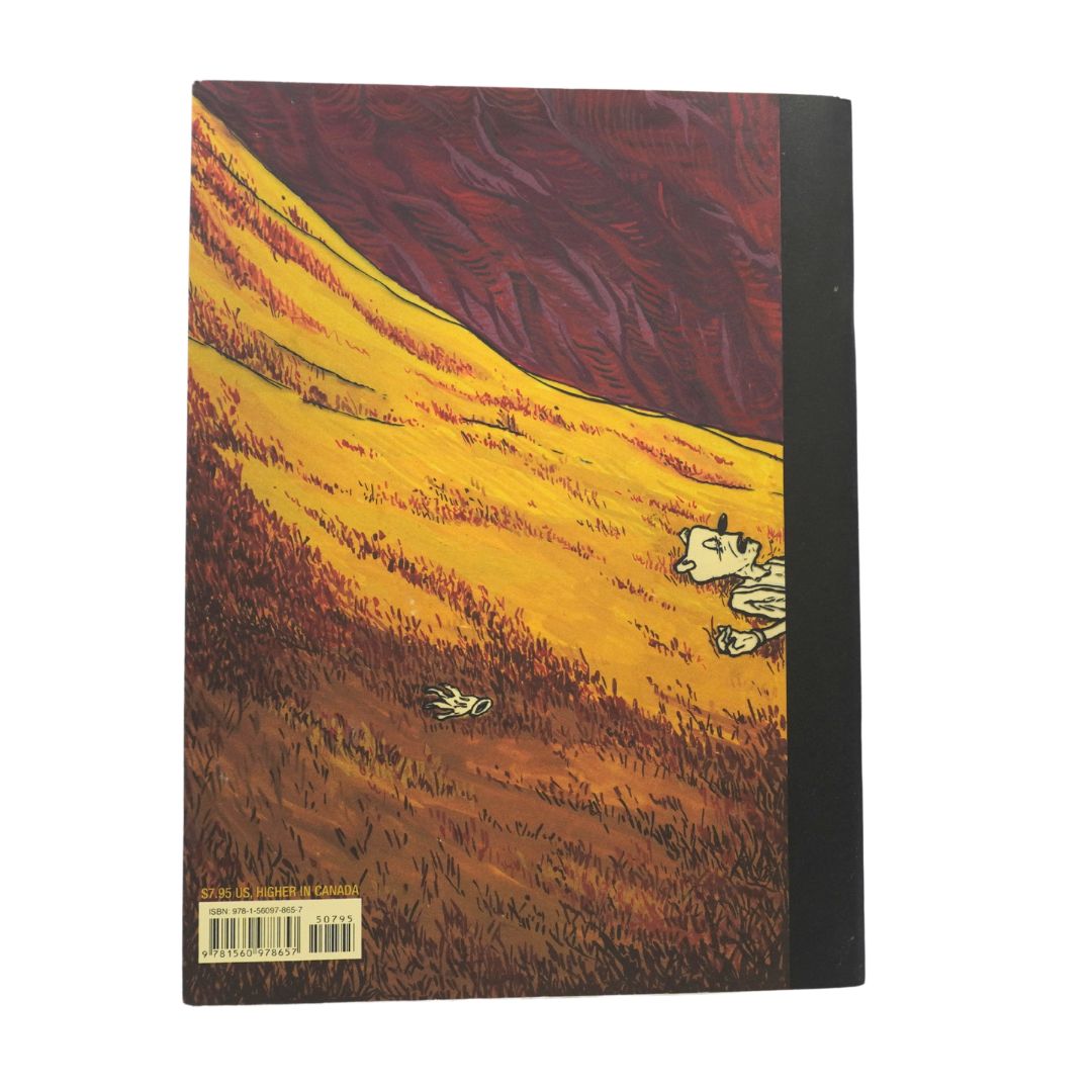 A softcover art book or notebook shown from the back, featuring a stylized illustration of a yellow field under a dark red sky with a small white dog lying on the ground. The book has a black spine and a barcode sticker at the bottom left.