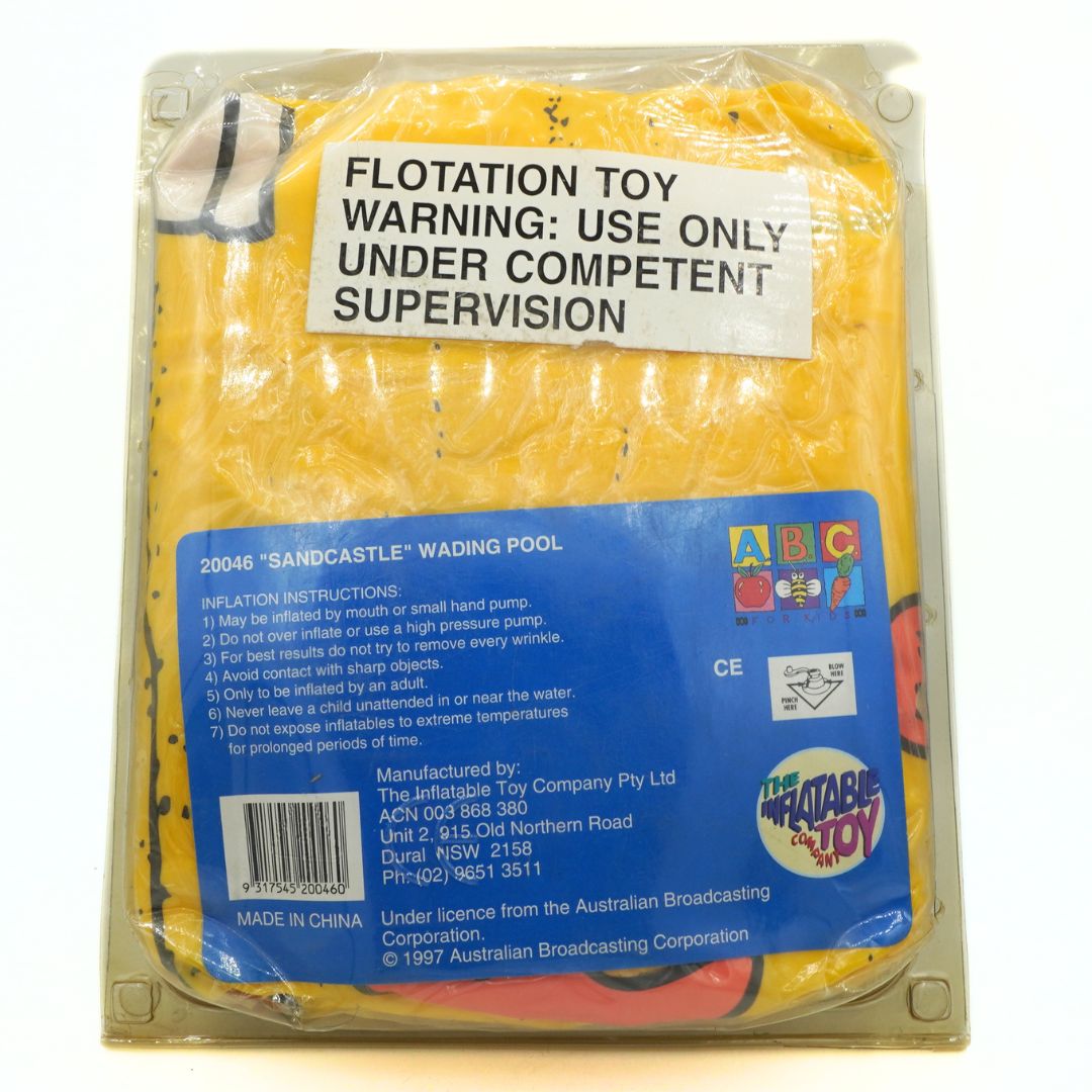 Packaged yellow sandcastle wading pool with warning label and branding on a white background